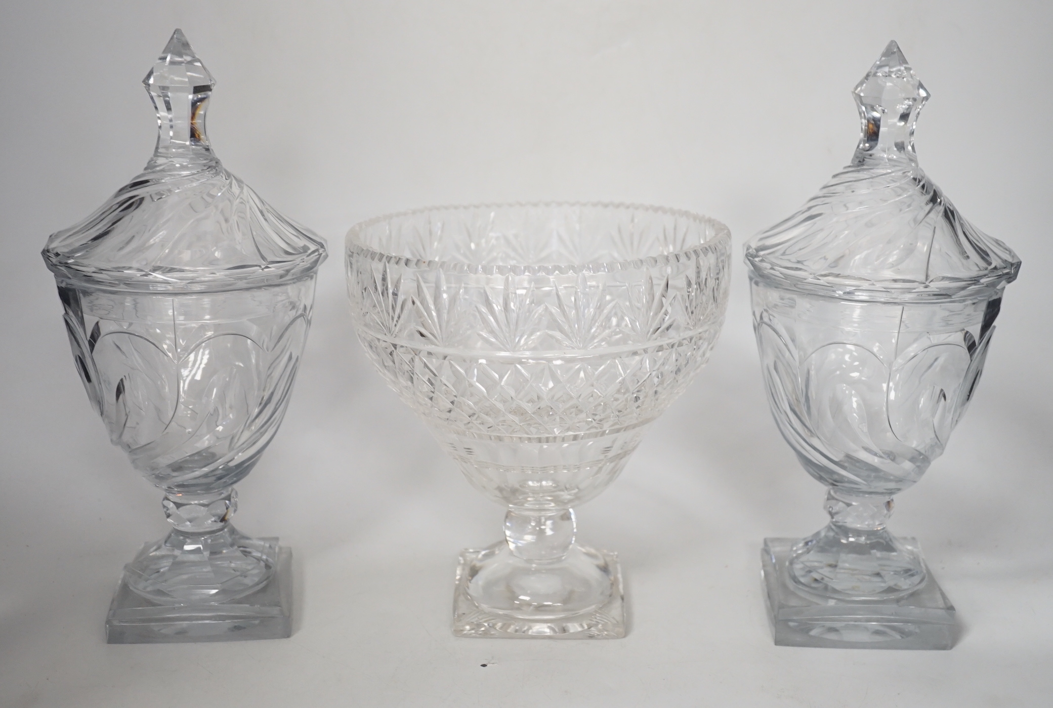 A pair of Regency Irish cut glass sweetmeat vases and covers, 30cm high and an Edwardian cut glass pedestal vase (3)